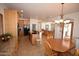 Kitchen features wood cabinets, granite countertops, eat-in table, and black appliances at 19880 W Desert Views Dr, Casa Grande, AZ 85122