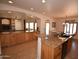 Open-concept kitchen with granite counters, and views to the dining and living areas at 19880 W Desert Views Dr, Casa Grande, AZ 85122