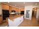 Kitchen features custom wood cabinets, granite countertops, a pantry, and modern appliances at 19880 W Desert Views Dr, Casa Grande, AZ 85122