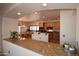 Kitchen and breakfast nook boasts granite countertops and natural wood cabinets at 19880 W Desert Views Dr, Casa Grande, AZ 85122