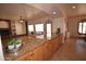 Modern kitchen with custom granite countertop open to the living room and natural fireplace at 19880 W Desert Views Dr, Casa Grande, AZ 85122
