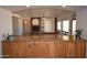 Open concept kitchen boasts a granite countertop, custom cabinets, and living room access at 19880 W Desert Views Dr, Casa Grande, AZ 85122
