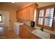 Functional laundry room with custom cabinetry, granite counters, sink, and modern washer and dryer at 19880 W Desert Views Dr, Casa Grande, AZ 85122