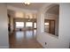 Bright and airy living room showcasing tile flooring, stone fireplace and view to front yard at 19880 W Desert Views Dr, Casa Grande, AZ 85122