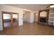 Spacious living room with stone fireplace and beautiful tile flooring at 19880 W Desert Views Dr, Casa Grande, AZ 85122