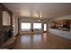 Spacious living room with stone fireplace, tile floors, and natural light from large windows at 19880 W Desert Views Dr, Casa Grande, AZ 85122