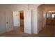 Bright main bedroom with open doorways leading to a bathroom and laundry room with a washer and dryer at 19880 W Desert Views Dr, Casa Grande, AZ 85122