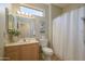 Clean and functional secondary bathroom with a single vanity, shower/tub combination, and light color palette at 20039 N Hearthstone Dr, Surprise, AZ 85374