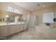 Serene primary bathroom featuring a shower, soaking tub, double vanity, and an abundance of natural light at 20039 N Hearthstone Dr, Surprise, AZ 85374