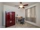 Functional bedroom with desk area, carpet, and a large steel safe at 20039 N Hearthstone Dr, Surprise, AZ 85374