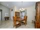 Formal dining room with a wooden table and chairs, and a china cabinet at 20039 N Hearthstone Dr, Surprise, AZ 85374