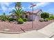 Well-landscaped corner lot with desert landscaping, mature trees, and a tile roof at 20039 N Hearthstone Dr, Surprise, AZ 85374