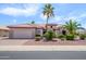 Single-story home with desert landscaping, large palm trees, and a neutral color scheme at 20039 N Hearthstone Dr, Surprise, AZ 85374
