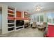 Comfortable game room featuring a pool table, cozy seating, fireplace, and built-in shelves at 20039 N Hearthstone Dr, Surprise, AZ 85374