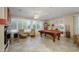 Bright game room featuring a pool table, leather chairs, and window shutters for natural light at 20039 N Hearthstone Dr, Surprise, AZ 85374