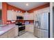 Well-equipped kitchen featuring stainless steel appliances and ample cabinet storage space at 20039 N Hearthstone Dr, Surprise, AZ 85374