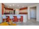 Bright kitchen with bar seating, red accent wall, and stainless steel appliances at 20039 N Hearthstone Dr, Surprise, AZ 85374