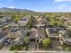 Birds-eye view showing the front exterior, tile roof, desert landscaping, and proximity to mountains at 20458 W Briarwood Dr, Buckeye, AZ 85396
