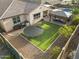 A spacious backyard with a patio, dining area, gazebo and a trampoline on artificial turf at 20458 W Briarwood Dr, Buckeye, AZ 85396