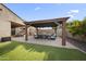 Outdoor living space with a covered patio and landscaped yard, perfect for entertaining at 20458 W Briarwood Dr, Buckeye, AZ 85396