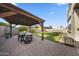 Landscaped backyard with a gazebo, trampoline, and lush green lawn at 20458 W Briarwood Dr, Buckeye, AZ 85396