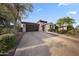 Inviting home exterior with a manicured front yard, paved driveway, and attached garage at 20458 W Briarwood Dr, Buckeye, AZ 85396