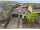 Beautiful single-story home featuring a paver driveway, two-car garage, and desert landscaping at 20458 W Briarwood Dr, Buckeye, AZ 85396