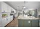 Open kitchen boasts white cabinets, stainless steel appliances, and a large island with seating at 20458 W Briarwood Dr, Buckeye, AZ 85396