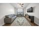 A modern living room featuring a plush gray couch, media center, and a large decorative rug at 20458 W Briarwood Dr, Buckeye, AZ 85396