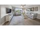 Bright living room featuring tile floors, large windows, a gray sofa and a vintage-inspired rug at 20458 W Briarwood Dr, Buckeye, AZ 85396