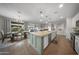 Open floor plan features a modern kitchen island that connects to the dining and living areas at 20458 W Briarwood Dr, Buckeye, AZ 85396