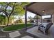 A serene backyard with lush artificial grass, mature landscaping, and a refreshing pool, perfect for outdoor living at 2119 E Daley Ln, Phoenix, AZ 85024