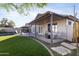 Inviting backyard boasts a covered patio, manicured artificial lawn, and sparkling pool for outdoor relaxation at 2119 E Daley Ln, Phoenix, AZ 85024