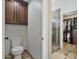 Ensuite bathroom with walk-in shower, toilet, and walk-in closet with custom built-ins at 2119 E Daley Ln, Phoenix, AZ 85024