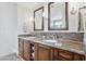 Bathroom with double vanity, granite countertops, wood cabinets, and custom lighting at 2119 E Daley Ln, Phoenix, AZ 85024