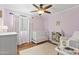 Bedroom with a crib, a white dresser, hardwood floors and a ceiling fan at 2119 E Daley Ln, Phoenix, AZ 85024