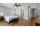 Spacious bedroom with wood floors, king size bed, neutral paint, and view to the ensuite bathroom at 2119 E Daley Ln, Phoenix, AZ 85024