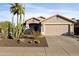 Charming home featuring desert landscaping, a two-car garage, and a welcoming front porch with a decorative sunburst at 2119 E Daley Ln, Phoenix, AZ 85024