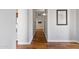 Hallway with wood floors, white walls, and access to other rooms in the home at 2119 E Daley Ln, Phoenix, AZ 85024