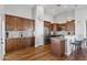 Spacious kitchen with wood cabinetry, granite countertops, stainless steel appliances, and hardwood flooring at 2119 E Daley Ln, Phoenix, AZ 85024