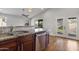 Kitchen island with stainless steel appliances, granite countertop, hardwood flooring and an open kitchen space at 2119 E Daley Ln, Phoenix, AZ 85024