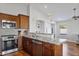 Kitchen featuring granite countertops, stainless steel appliances, dark wood cabinetry, and an open design at 2119 E Daley Ln, Phoenix, AZ 85024