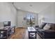 Bright living room with hardwood floors, a large window, and comfortable seating, creating a welcoming atmosphere at 2119 E Daley Ln, Phoenix, AZ 85024