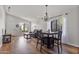 Open floor plan with hardwood floors, dining area, and a living room with large windows, creating a bright and airy feel at 2119 E Daley Ln, Phoenix, AZ 85024