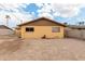 View of the backyard with painted walls, clear skies, and dirt landscaping, ideal for customization and outdoor living at 2132 W Chambers St, Phoenix, AZ 85041
