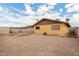 Spacious backyard with potential for various uses, featuring painted walls and dirt landscaping for easy maintenance at 2132 W Chambers St, Phoenix, AZ 85041