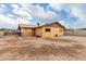 Backyard with unkempt desert landscaping, block wall, and blue sky with clouds at 2132 W Chambers St, Phoenix, AZ 85041
