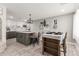A modern kitchen features an island with seating, decorative wall art, and hardwood-style floors at 2132 W Chambers St, Phoenix, AZ 85041