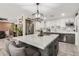 The updated kitchen features a large island, stainless steel appliances, and a pantry with a barn door at 2132 W Chambers St, Phoenix, AZ 85041