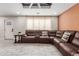 Spacious living room with stylish tile flooring, recessed lights, and a comfortable leather sectional sofa at 2132 W Chambers St, Phoenix, AZ 85041